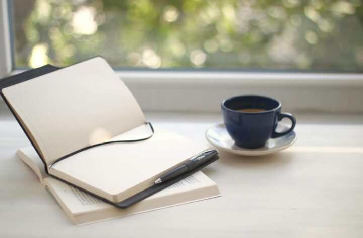 Calm workspace with notepads and a cup of coffee